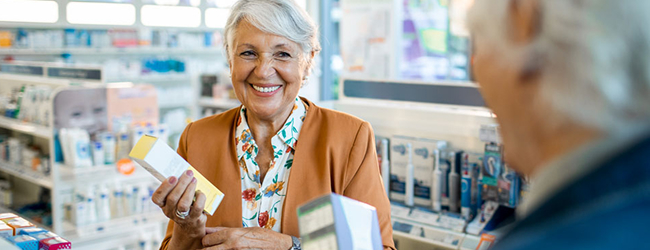 A person picking up her medication at the pharmacy